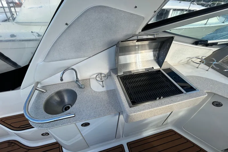 Slide: The Image of 2010 Sea Ray Sundancer 330 yacht kitchenette with sink and grill. - 4