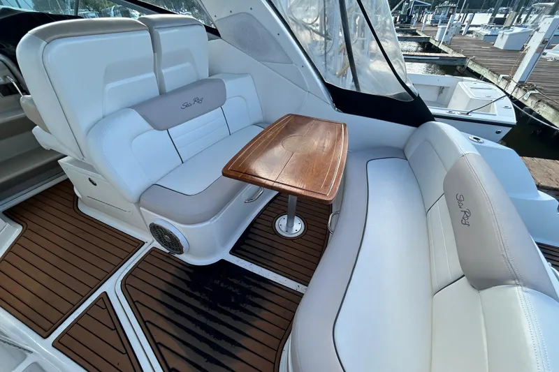Slide: The Image of Luxurious 2010 Sea Ray Sundancer 330 interior with elegant seating and wooden table. - 9