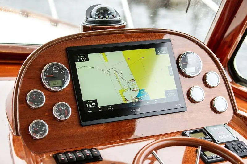 Slide: The Image of Hinckley Picnic Boat MKIII 2010 dashboard with Garmin navigation display and gauges. - 17