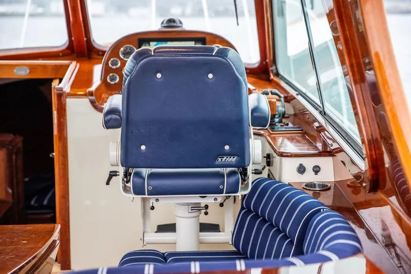 Slide: The Image of Interior of 2010 Hinckley Picnic Boat MKIII with blue seating and wooden dashboard. - 20