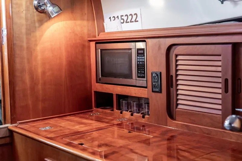 Slide: The Image of Interior of 2010 Hinckley Picnic Boat MKIII with wooden cabinetry and built-in microwave. - 22