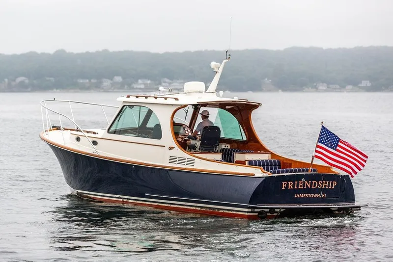 Slide: The Image of Hinckley Picnic Boat MKIII 2010 cruising on water with American flag, named "Friendship". - 4