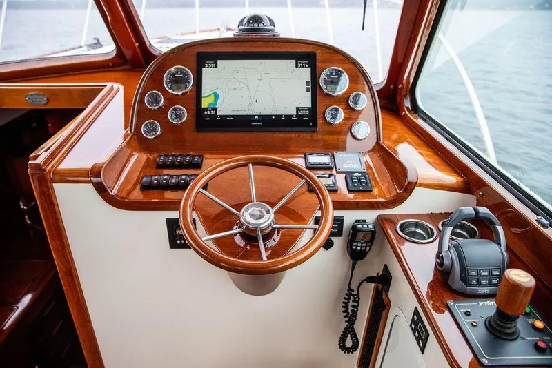 Slide: The Image of Helm of 2010 Hinckley Picnic Boat MKIII with navigation controls and wooden steering wheel. - 18