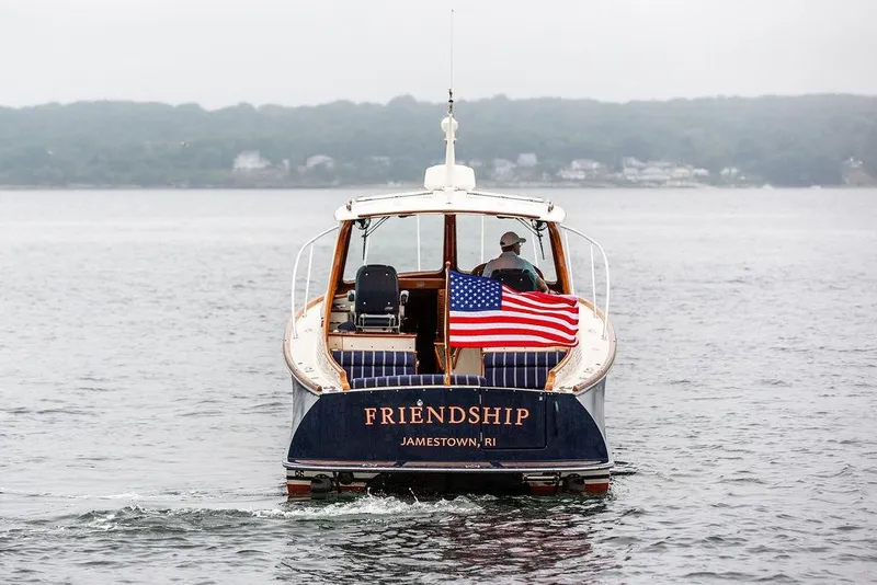 Slide: The Image of Hinckley Picnic Boat MKIII 2010 cruising with American flag, labeled "Friendship," in Jamestown, RI waters. - 3