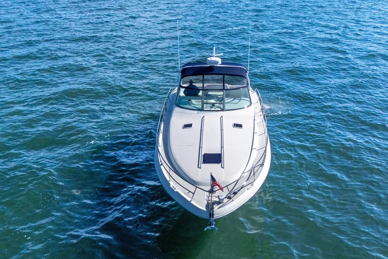 Slide: The Image of 1997 Sea Ray 400 Sundancer yacht cruising on open water, aerial view. - 14