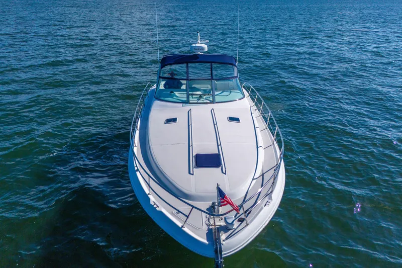Slide: The Image of 1997 Sea Ray 400 Sundancer yacht cruising on open water, aerial view. - 9
