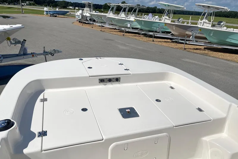 Slide: The Image of 2026 Carolina Skiff 19 LS boat deck, white finish, parked with other boats. - 12