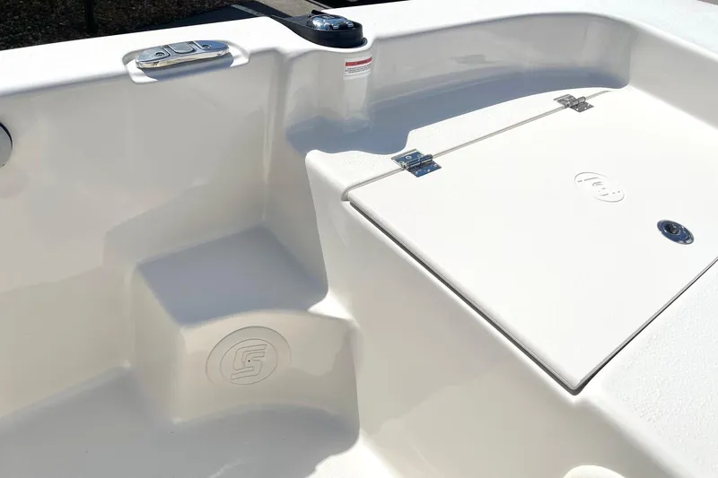 Slide: The Image of 2026 Carolina Skiff 19 LS boat interior, featuring storage compartment and seating area. - 14