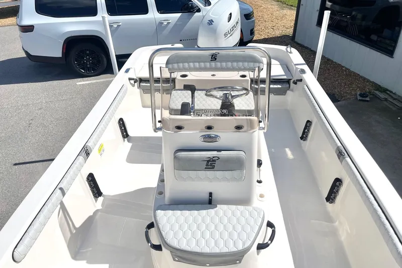 Slide: The Image of 2026 Carolina Skiff 19 LS boat interior with seating and steering console. - 15