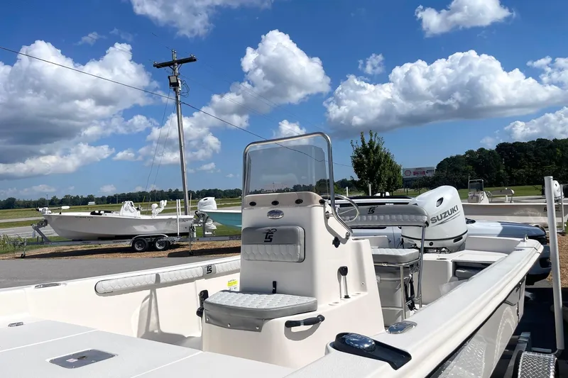 Slide: The Image of 2026 Carolina Skiff 19 LS boat with Suzuki engine under a clear blue sky. - 16