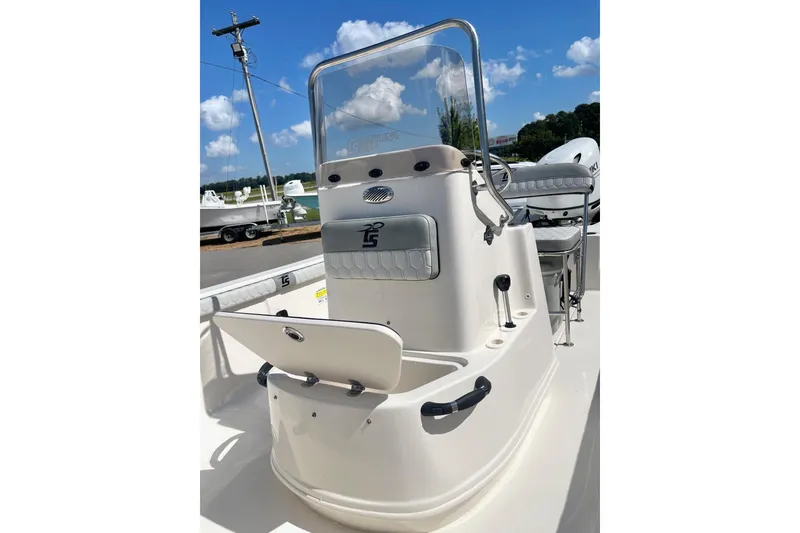 Slide: The Image of 2026 Carolina Skiff 19 LS boat console with seating, outdoors under blue sky. - 18