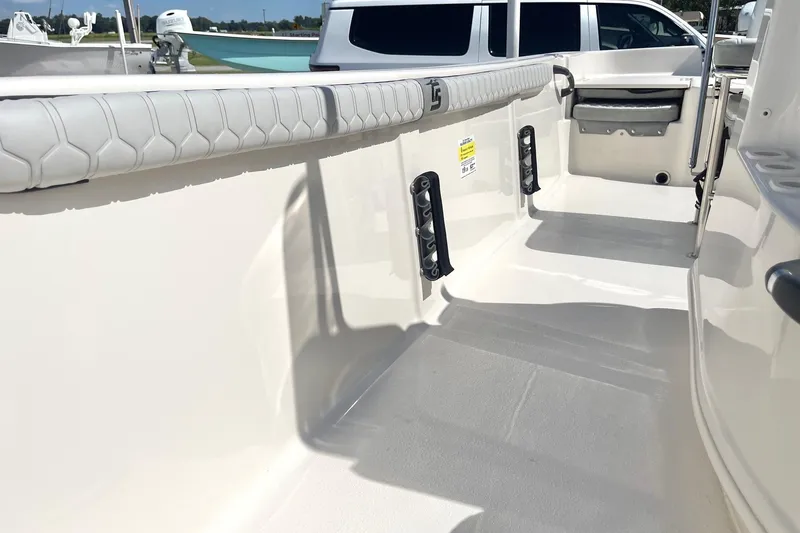 Slide: The Image of 2026 Carolina Skiff 19 LS boat interior with padded seating and storage compartments. - 20