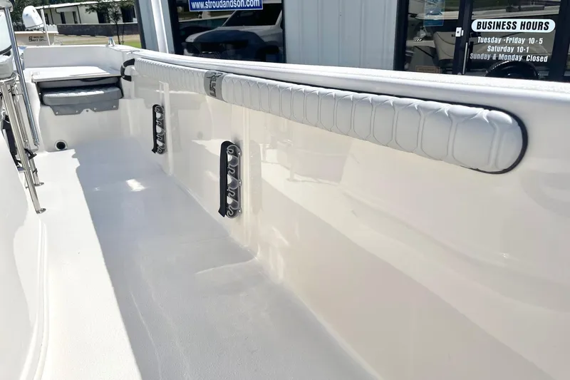Slide: The Image of 2026 Carolina Skiff 19 LS boat interior with padded side rail and storage compartments. - 21