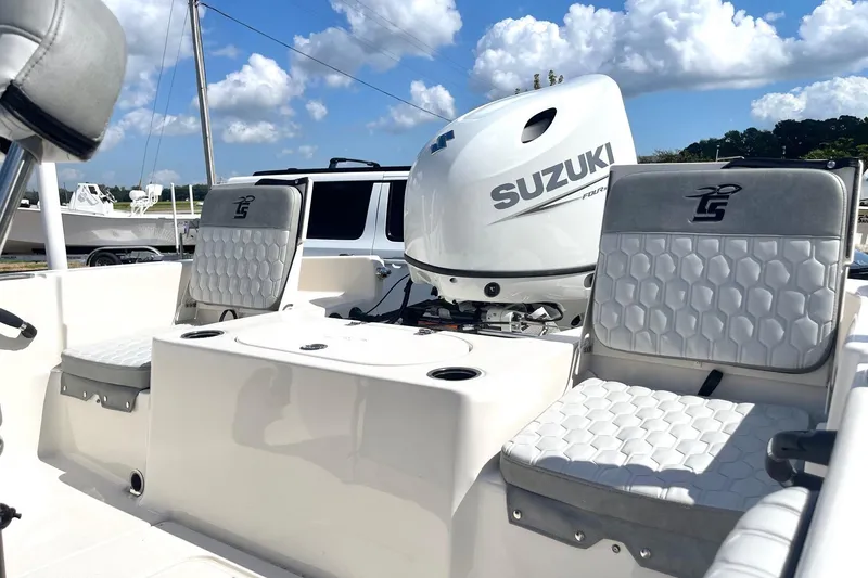 Slide: The Image of 2026 Carolina Skiff 19 LS boat interior with Suzuki engine, featuring cushioned seating. - 28