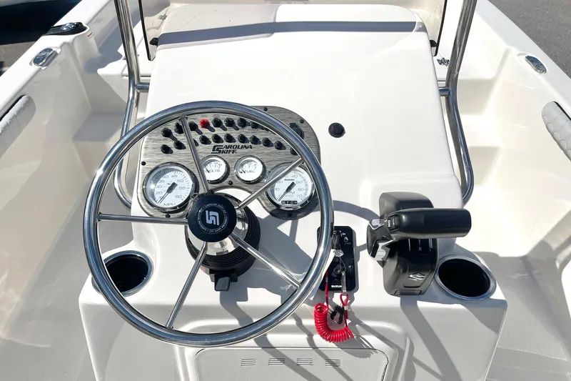 Slide: The Image of 2026 Carolina Skiff 19 LS boat dashboard with steering wheel and controls. - 3