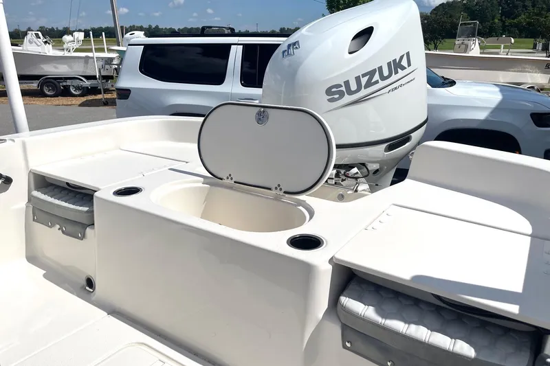 Slide: The Image of 2026 Carolina Skiff 19 LS boat with Suzuki outboard motor, featuring storage compartments. - 31