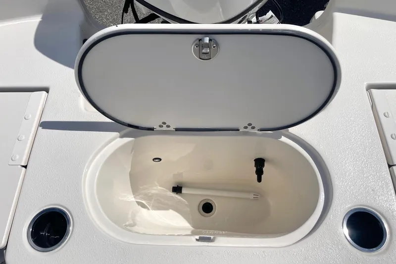 Slide: The Image of Open storage compartment on 2026 Carolina Skiff 19 LS boat deck. - 32