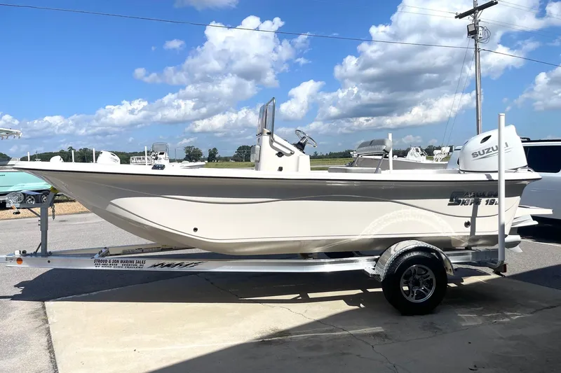 Slide: The Image of 2026 Carolina Skiff 19 LS boat on trailer under a clear blue sky. - 4