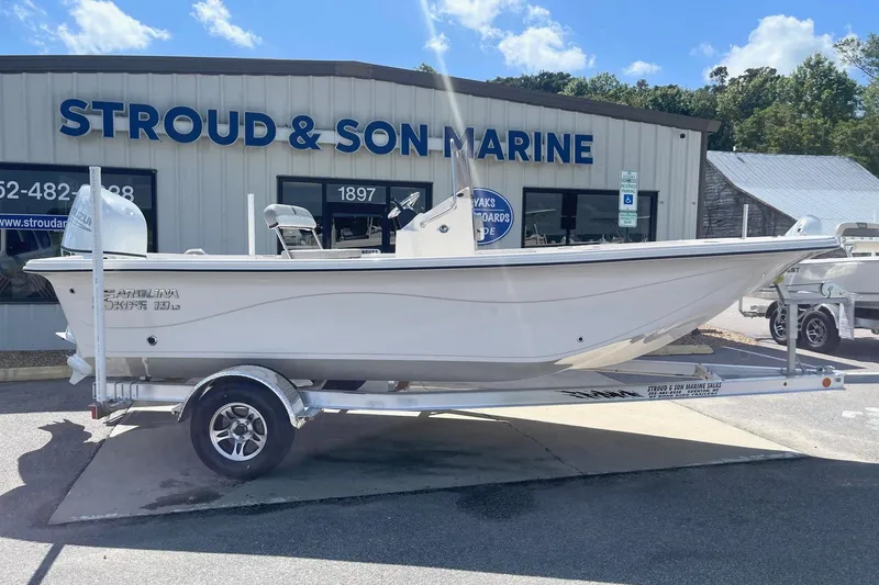 Slide: The Image of 2026 Carolina Skiff 19 LS boat on trailer at Stroud & Son Marine dealership. - 6
