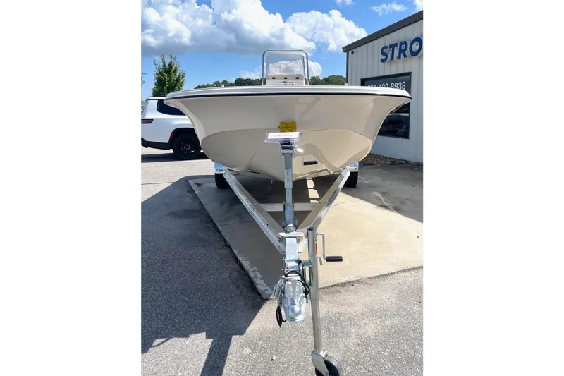 Slide: The Image of 2026 Carolina Skiff 19 LS boat on trailer, parked outdoors under blue sky. - 8
