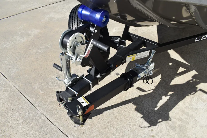 Slide: The Image of 2026 Lowe Stinger 175C boat interior with carpeted flooring and safety warning label. - 11