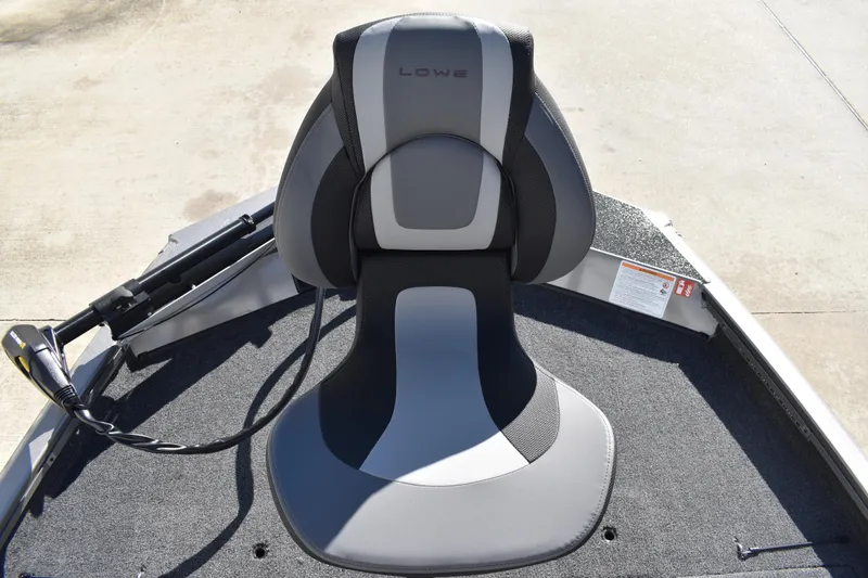 Slide: The Image of 2026 Lowe Stinger 175C boat interior with carpeted deck and steering wheel. - 14