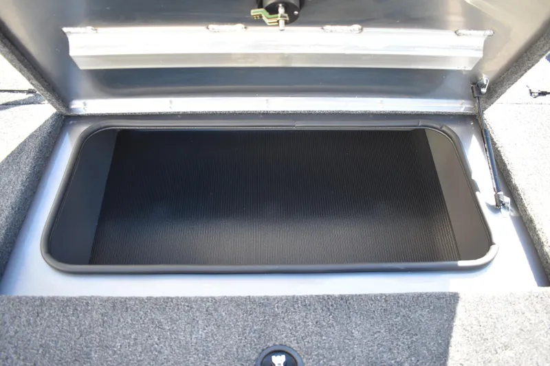 Slide: The Image of 2026 Lowe Stinger 175C boat interior with carpeted flooring and storage compartment. - 16