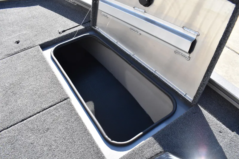 Slide: The Image of 2026 Lowe Stinger 175C boat deck with carpeted surface and storage compartments. - 18
