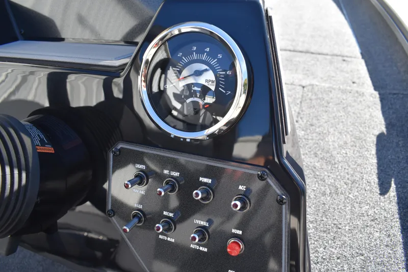 Slide: The Image of 2026 Lowe Stinger 175C boat dashboard with steering wheel and gauges. - 31
