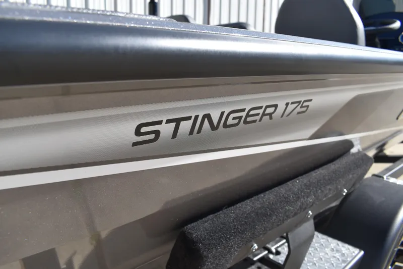 Slide: The Image of 2026 Lowe Stinger 175C boat with metallic logo detail. - 4
