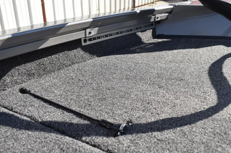 Slide: The Image of 2026 Lowe Stinger 175C boat deck with storage compartments and motor. - 42