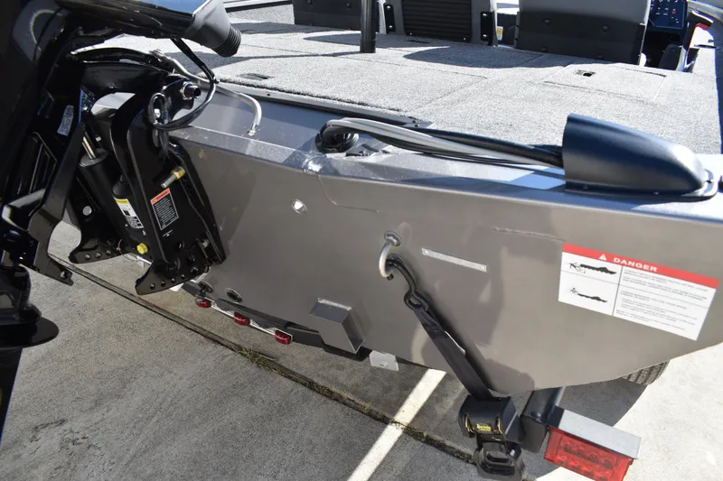 Slide: The Image of 2026 Lowe Stinger 175C fishing boat with seating and trailer in outdoor setting. - 6