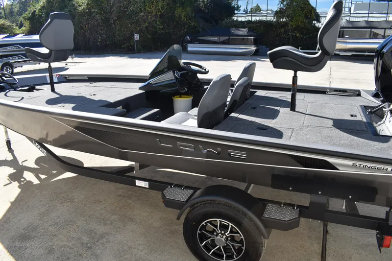 Slide: The Image of 2026 Lowe Stinger 175C boat rear view, showcasing motor and deck details. - 9