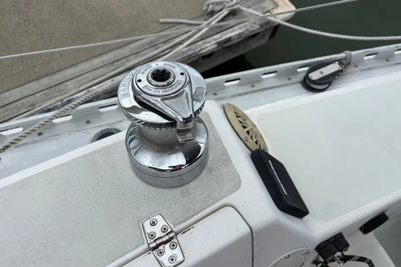 Slide: The Image of Winch on 1988 J Boats J/28 sailboat deck, featuring chrome finish and rigging details. - 16