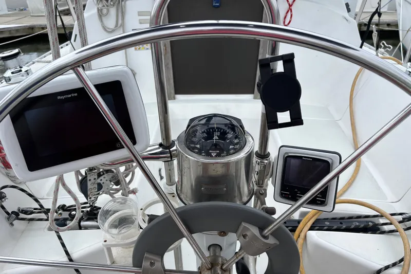 Slide: The Image of Cockpit of 1988 J Boats J/28 sailboat with navigation instruments and steering wheel. - 17