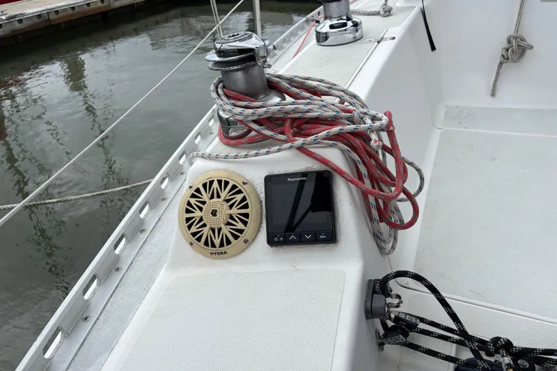 Slide: The Image of 1988 J Boats J/28 sailboat cockpit with ropes, winch, speaker, and Raymarine display. - 18