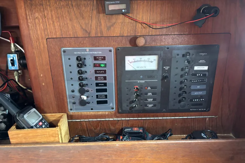 Slide: The Image of Electrical control panel on a 1988 J Boats J/28 sailboat, featuring various switches and meters. - 24