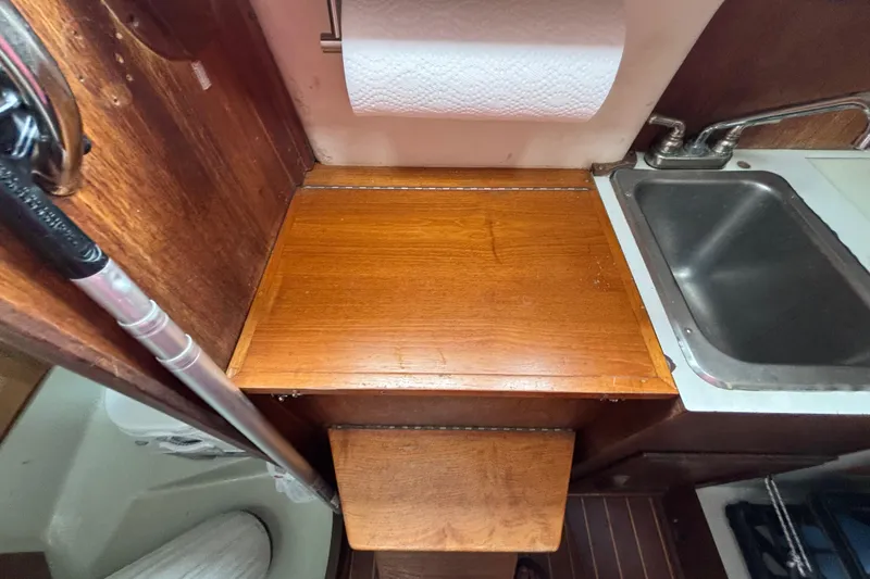 Slide: The Image of 1988 J Boats J/28 interior galley with wooden countertop and stainless steel sink. - 27