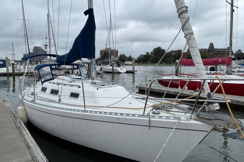 Slide: The Image of 1988 J Boats J/28 sailboat docked at marina on a cloudy day. - 3