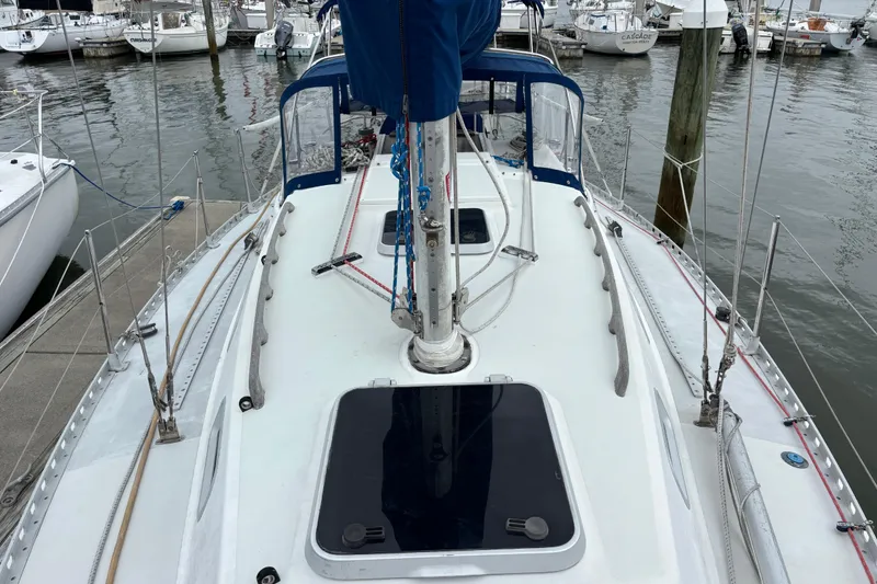 Slide: The Image of 1988 J Boats J/28 sailboat docked at marina, featuring deck and rigging. - 4