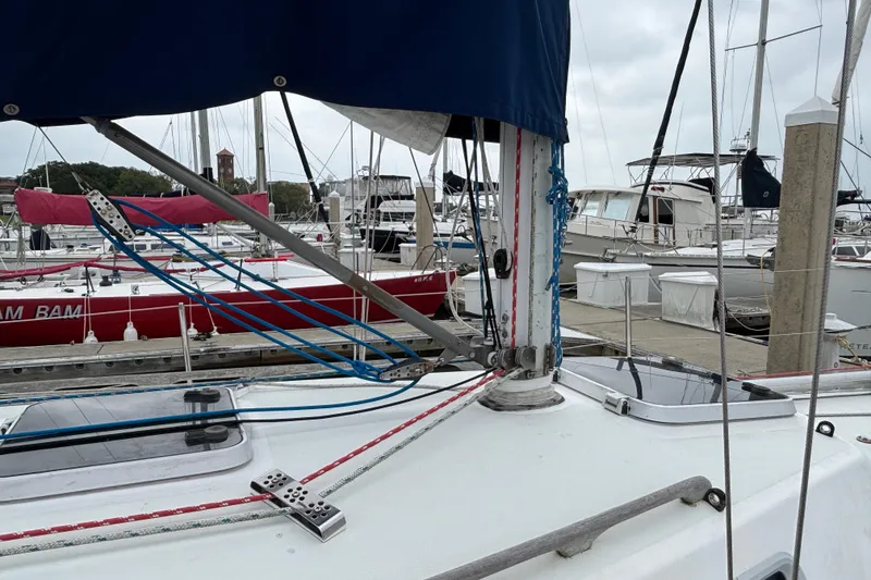 Slide: The Image of 1988 J Boats J/28 sailboat docked at marina, featuring rigging and deck details. - 5
