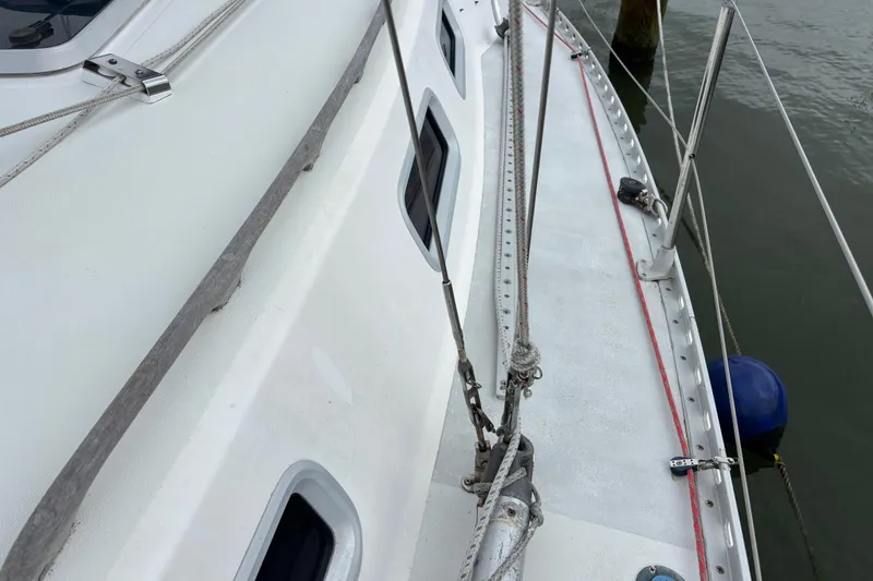 Slide: The Image of 1988 J Boats J/28 sailboat deck with rigging and dock view. - 7
