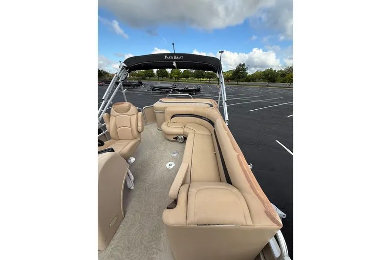 Slide: The Image of 2008 Parti Kraft 240RE pontoon boat with beige seating in a parking lot. - 4