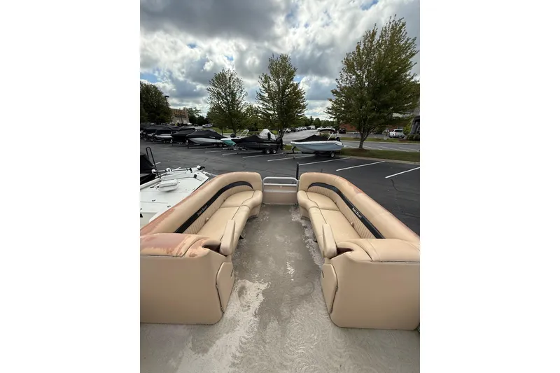 Slide: The Image of 2008 Parti Kraft 240RE pontoon boat with beige seating, parked outdoors under cloudy skies. - 5