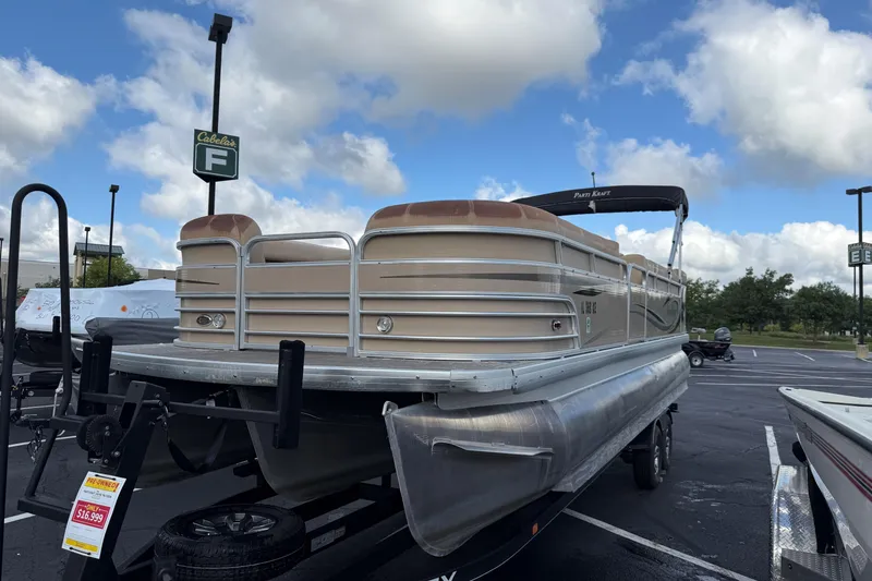 Slide: The Image of 2008 Parti Kraft 240RE pontoon boat on trailer in parking lot under cloudy sky. - 6