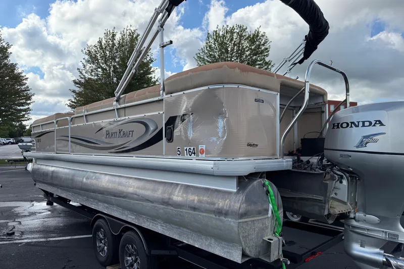 Slide: The Image of 2008 Parti Kraft 240RE pontoon boat with Honda motor on trailer, parked outdoors. - 7
