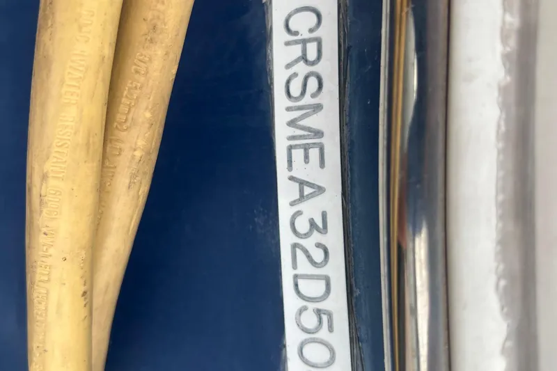 Slide: The Image of Serial number on 2005 Cruisers Yachts 400 Express, with yellow cables visible. - 11