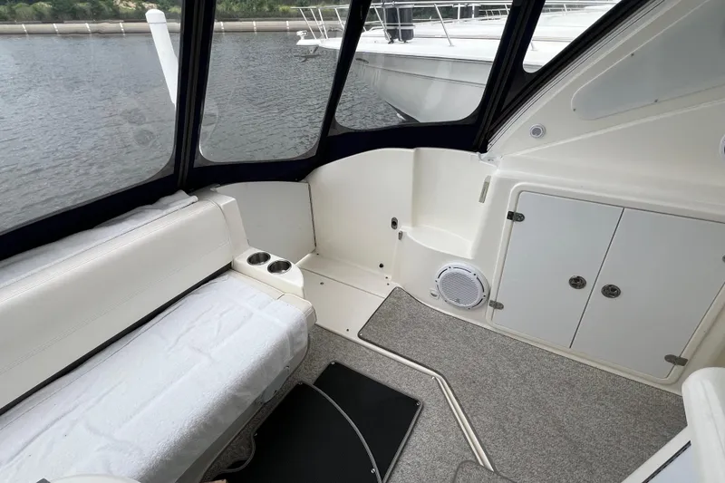Slide: The Image of 2005 Cruisers Yachts 400 Express interior with seating, storage, and water view. - 14