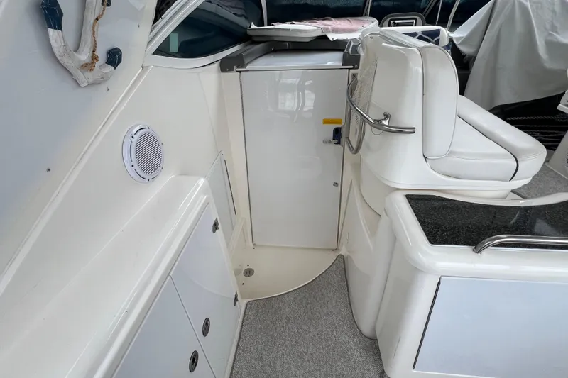 Slide: The Image of 2005 Cruisers Yachts 400 Express interior with white seating and storage compartments. - 15