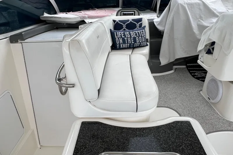 Slide: The Image of 2005 Cruisers Yachts 400 Express interior with white seating and decorative pillow. - 16